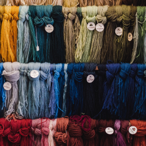 Close-up of textiles hanging up in a shop.